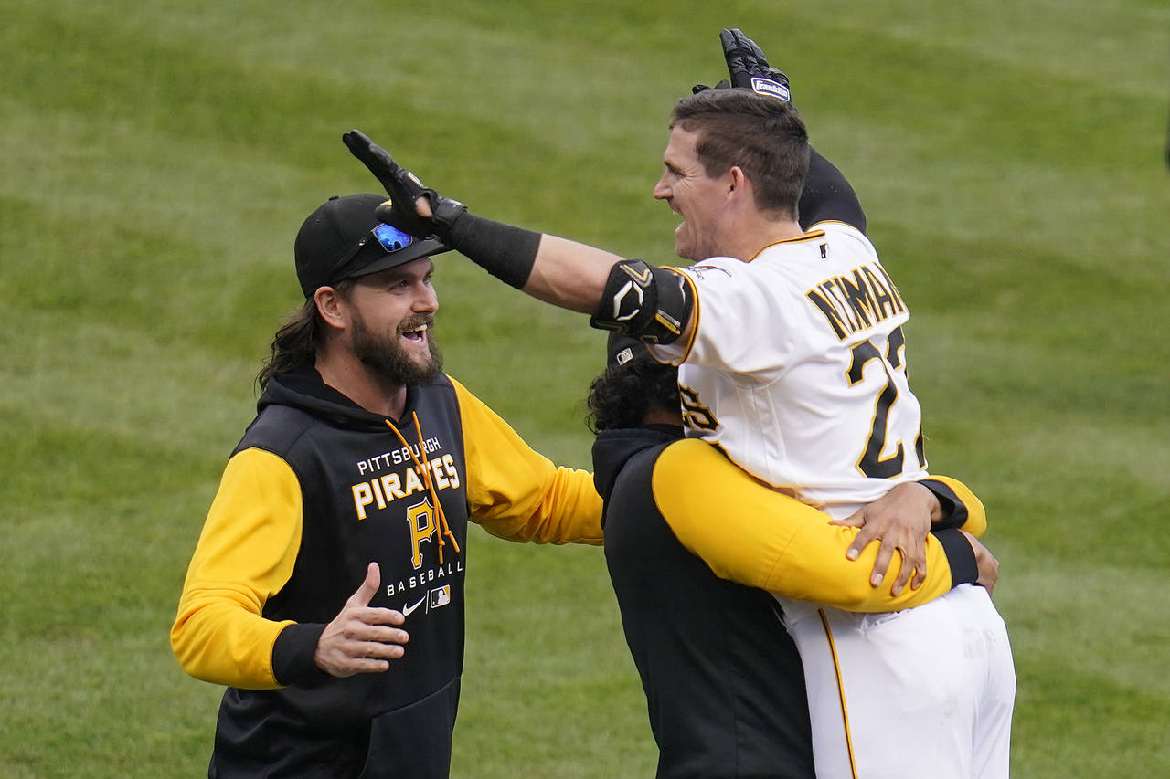 Pittsburgh Pirates' Kevin Newman, right, celebrates with teammates after hitting the game-winning R...