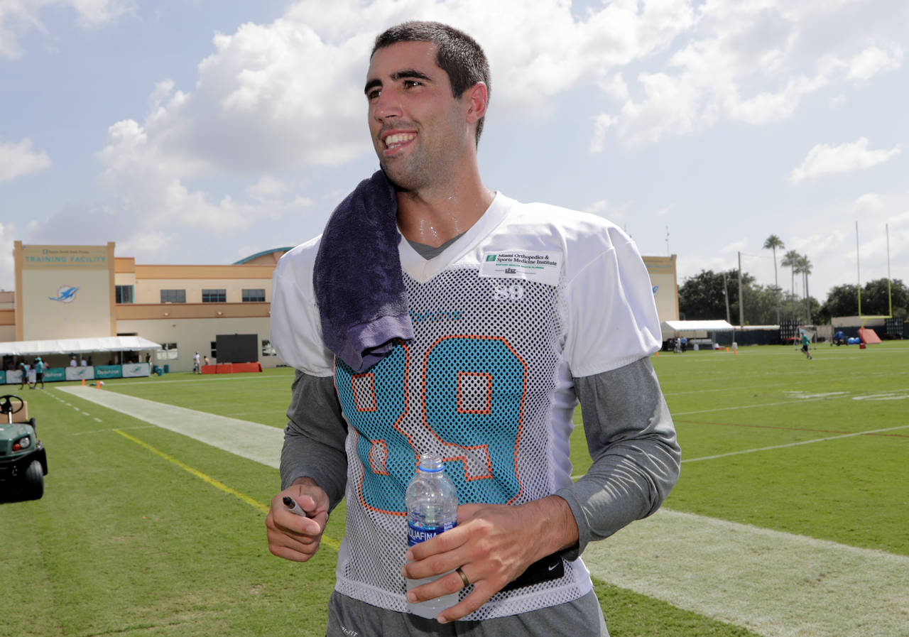 FILE - Miami Dolphins tight end Gavin Escobar walks off the field at the NFL team's training camp, ...