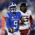 
              Kentucky wide receiver Tayvion Robinson (9) runs the ball into the end zone for a touchdown while being chased by Northern Illinois cornerback Cyrus McGarrell (22) during the second half of an NCAA college football game in Lexington, Ky., Saturday, Sept. 24, 2022. (AP Photo/Michael Clubb)
            
