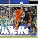 
              Houston Dynamo goalkeeper Steve Clark, left, looks on as defender Ethan Bartlow (13) headers away a shot on goal over Los Angeles FC midfielders Gareth Bale (11) and defender Jesus Murillo (3) during the second half of an MLS soccer match Wednesday, Aug. 31, 2022, in Houston. (AP Photo/Michael Wyke)
            