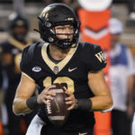 
              Wake Forest quarterback Mitch Griffis (12) looks to pass against VMI during the second half of an NCAA college football game in Winston-Salem, N.C., Thursday, Sept. 1, 2022. (AP Photo/Chuck Burton)
            