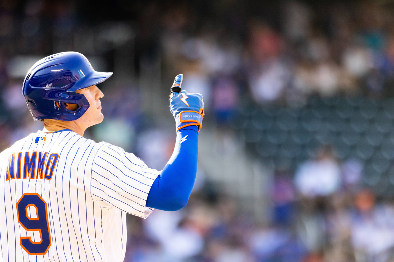 New York Mets' Brandon Nimmo points to the sky while at first base during the eighth inning of a ba...