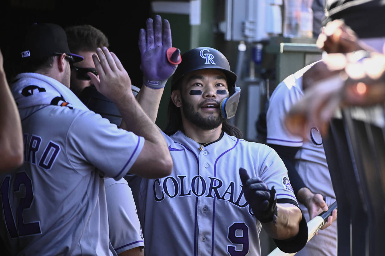 Colorado Rockies' Connor Joe (9) celebrates in the dugout after hitting a home run against the Chic...