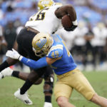 
              UCLA linebacker Carson Schwesinger (49) tackles Alabama State running back Marcus Harris II (26) during the second half of an NCAA college football game in Pasadena, Calif., Saturday, Sept. 10, 2022. (AP Photo/Ashley Landis)
            