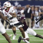 
              Arkansas wide receiver Jadon Haselwood (9) is tackled by Texas A&M defensive back Demani Richardson (26) during the second half of an NCAA college football game Saturday, Sept. 24, 2022, in Arlington, Texas. Texas A&M won 23-21. (AP Photo/Brandon Wade)
            