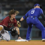 
              Arizona Diamondbacks Jake McCarthy, left, is is caught stealing second by Los Angeles Dodgers second baseman Gavin Lux (9) during the ninth inning of a baseball game in Los Angeles, Thursday, Sept. 22, 2022. (AP Photo/Ashley Landis)
            
