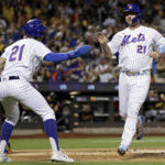 
              New York Mets' Pete Alonso, right, celebrates with Jeff McNeil after they scored against the Pittsburgh Pirates during the first inning of a baseball game Thursday, Sept. 15, 2022, in New York. (AP Photo/Adam Hunger)
            