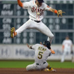 
              Oakland Athletics' Tony Kemp (5) steals second base as Houston Astros shortstop David Hensley (17) jumps to avoid him during the ninth inning of a baseball game Saturday, Sept. 17, 2022, in Houston. (AP Photo/David J. Phillip)
            