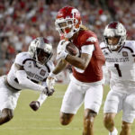 
              Arkansas wide receiver Jadon Haselwood, center, slips past Missouri State defenders Caleb Blake, left, and Aaron Harris (1) to score a touchdown during the first half of an NCAA college football game Saturday, Sept. 17, 2022, in Fayetteville, Ark. (AP Photo/Michael Woods)
            