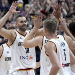 
              Germany's Jonas Wohlfarth-Bottermann, left, and his teammates celebrate after the Eurobasket quarterfinal basketball match between Germany and Greece in Berlin, Germany, Tuesday, Sept. 13, 2022. Germany defeated Greece by 107-96. (AP Photo/Michael Sohn)
            