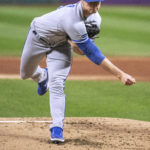 
              Kansas City Royals starting pitcher Brady Singer delivers against the Cleveland Guardians during the first inning of a baseball game in Cleveland, Friday, Sept. 30, 2022. (AP Photo/Phil Long)
            