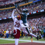 
              Philadelphia Eagles wide receiver DeVonta Smith (6) makes a touchdown catch against the Washington Commanders cornerback Kendall Fuller (29) during the first half of an NFL football game, Sunday, Sept. 25, 2022, in Landover, Md. (AP Photo/Nick Wass)
            
