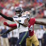 
              Seattle Seahawks quarterback Geno Smith (7) passes as San Francisco 49ers defensive end Charles Omenihu applies pressure during the first half of an NFL football game in Santa Clara, Calif., Sunday, Sept. 18, 2022. (AP Photo/Tony Avelar)
            