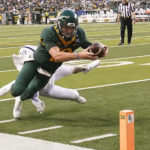 
              Baylor quarterback Blake Shapen (12) dives to score a touchdown against Albany defensive back Isaac Duffy (19) during the first half of an NCAA college football game in Waco, Texas, Saturday, Sept. 3, 2022. (AP Photo/LM Otero)
            