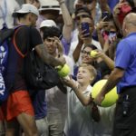 
              Nick Kyrgios, of Australia, signs autographs after winning his match against Daniil Medvedev, of Russia, during the fourth round of the U.S. Open tennis championships, Sunday, Sept. 4, 2022, in New York. (AP Photo/Adam Hunger)
            