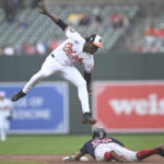 
              Baltimore Orioles' Jorge Mateo, top, jumps over Boston Red Sox's Tommy Pham on a steal in the first inning of a baseball game, Sunday, Sept. 11, 2022, in Baltimore. (AP Photo/Gail Burton)
            