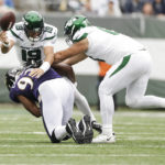 
              New York Jets quarterback Joe Flacco (19) is hit by Baltimore Ravens' Calais Campbell (93) during the first half of an NFL football game Sunday, Sept. 11, 2022, in East Rutherford, N.J. (AP Photo/Adam Hunger)
            