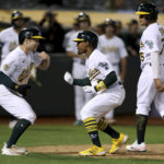 
              Oakland Athletics' Tony Kemp, center, celebrates with Nick Allen, left, and Jordan Diaz, right, after hitting a three-run home run against the Seattle Mariners during the fifth inning of a baseball game in Oakland, Calif., Tuesday, Sept. 20, 2022. (AP Photo/Jed Jacobsohn)
            