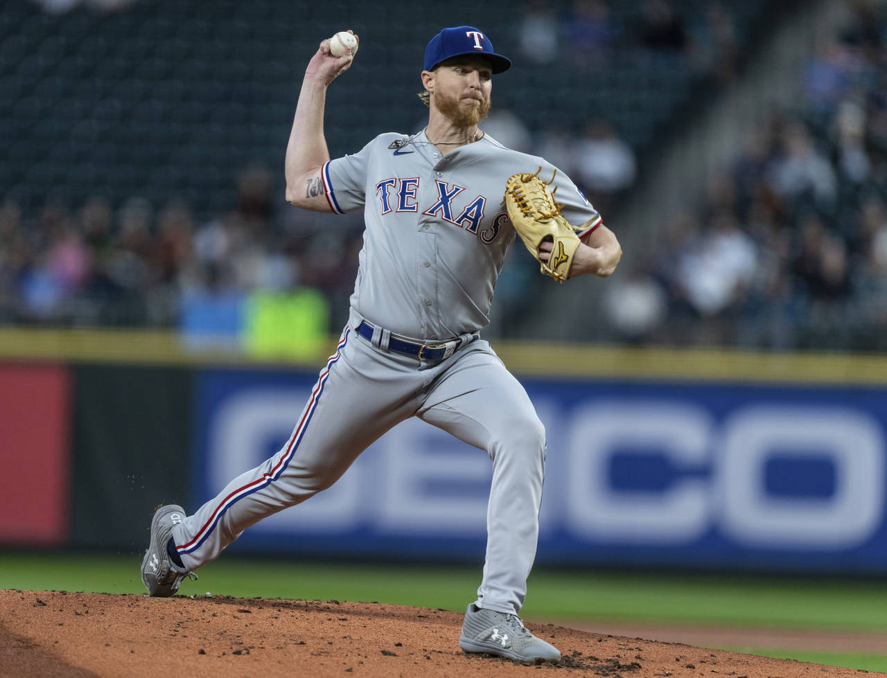 Texas Rangers starter Jon Gray throws during the first inning of the team's baseball game against t...