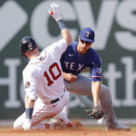 
              Texas Rangers shortstop Corey Seager, right, cannot apply a tag before Boston Red Sox' Trevor Story, left, safely reaches second after hitting a double during the fifth inning of a baseball game at Fenway Park, Sunday Sept. 4, 2022, in Boston.(AP Photo/Paul Connors)
            