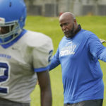 
              Murrah High School football coach Marcus Gibson encourages his quarterback Odarrius Harris (2) during practice, Wednesday, Aug. 31, 2022, in Jackson, Miss. The city's low water pressure concerns Gibson, limiting his options for washing practice uniforms, towels and other gear his players wear. The recent flood worsened Jackson's longstanding water system problems and the state Health Department has had Mississippi's capital city under a boil-water notice since late July. (AP Photo/Rogelio V. Solis)
            
