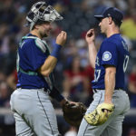 
              Seattle Mariners relief pitcher Matthew Festa, right, and catcher Cal Raleigh celebrate after the Mariners defeated the Cleveland Guardians 6-1 in a baseball game Friday, Sept. 2, 2022, in Cleveland. (AP Photo/David Dermer)
            