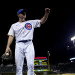 
              Chicago Cubs relief pitcher Hayden Wesneski gestures to the crowd as he leaves the field with the game ball during his Major League debut, in the team's 9-3 win over the Cincinnati Reds a baseball game Tuesday, Sept. 6, 2022, in Chicago. (AP Photo/Charles Rex Arbogast)
            