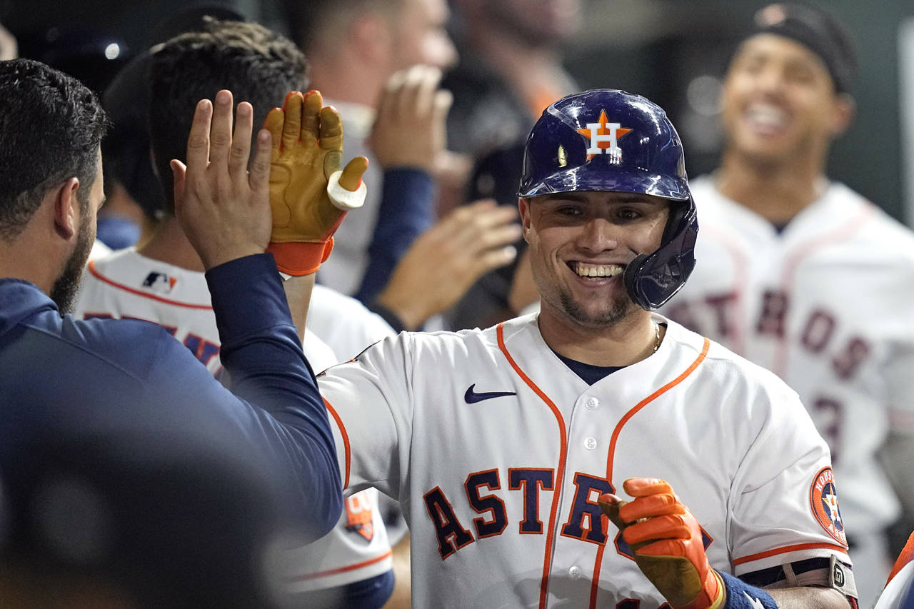 Houston Astros' Aledmys Diaz celebrates with teammates in the dugout after hitting a two-run home r...
