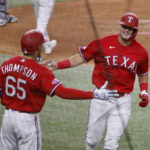 
              Texas Rangers' Bubba Thompson (65) congratulates Josh Jung after Jung hit his first home run on his first major league at-bat, against the Toronto Blue Jays during the third inning of a baseball game Friday, Sept. 9, 2022, in Arlington, Texas. (AP Photo/Michael Ainsworth)
            