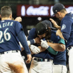 
              Seattle Mariners' Adam Frazier, J.P. Crawford and Chris Flexen, from left, celebrate after the team's baseball game against the Texas Rangers, Thursday, Sept. 29, 2022, in Seattle. The Mariners won 10-9 in 11 innings. (AP Photo/Stephen Brashear)
            