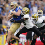 
              UCLA tight end Hudson Habermehl (81) runs to the end zone for a touchdown while defended by Alabama State defensive back Irshaad Davis (0) during the first half of an NCAA college football game in Pasadena, Calif., Saturday, Sept. 10, 2022. (AP Photo/Ashley Landis)
            