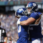
              New York Giants' Daniel Bellinger, right, celebrates his touchdown with Richie James during the second half an NFL football game against the Carolina Panthers, Sunday, Sept. 18, 2022, in East Rutherford, N.J. (AP Photo/John Munson)
            