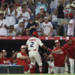 
              Los Angeles Angels second baseman Luis Rengifo, bottom center, celebrates with teammates after scoring a run during the seventh inning of a baseball game against the Houston Astros Saturday, Sept. 3, 2022, in Anaheim, Calif. The Angles won 2-1. (AP Photo/Raul Romero Jr.)
            