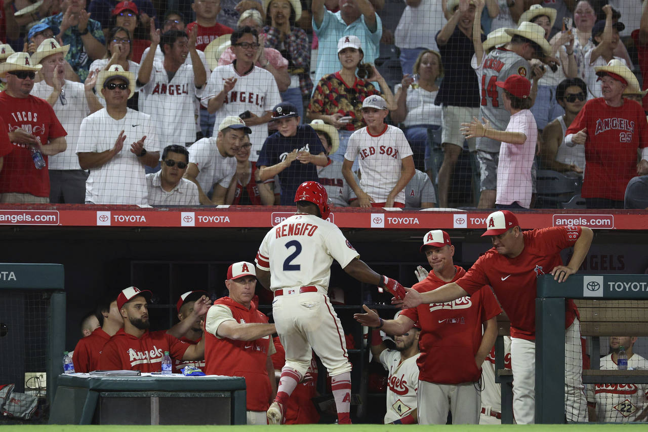 Los Angeles Angels second baseman Luis Rengifo, bottom center, celebrates with teammates after scor...