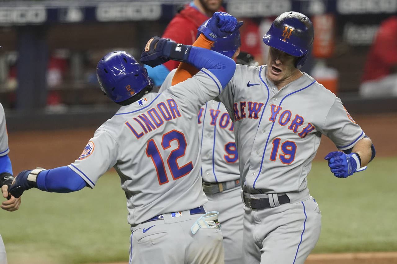 New York Mets' Mark Canha (19) celebrates with Francisco Lindor (12) after hitting a grand slam in ...