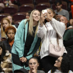 
              Connectiut women's basketball player Paige Bueckers poses for a selfie with a fan during Game 4 of a WNBA basketball playoff semifinal between the Connecticut Sun and the Chicago Sky, Tuesday, Sept. 6, 2022, in Uncasville, Conn. (AP Photo/Jessica Hill)
            
