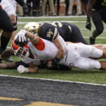 
              Clemson running back Will Shipley (1) reaches the ball over the goal line for a touchdown as Wake Forest linebacker Dylan Hazen (50) holds on during the second half of an NCAA college football game in Winston-Salem, N.C., Saturday, Sept. 24, 2022. (AP Photo/Chuck Burton)
            