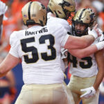 
              Purdue running back Devin Mockobee, right, celebrates with offensive lineman Gus Hartwig after scoring a touchdown against Syracuse during the first half of an NCAA college football game in Syracuse, N.Y., Saturday, Sept. 17, 2022. (AP Photo/Adrian Kraus)
            