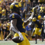 
              Michigan running back Blake Corum (2) celebrates an 11-yard touchdown against Connecticut by holding up five fingers in the second half of an NCAA college football game in Ann Arbor, Mich., Saturday, Sept. 17, 2022. Corum ran for five touchdowns in the game. (AP Photo/Paul Sancya)
            