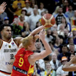 
              Spain's Alberto Diaz, center, is challenged by Germany's Johannes Thiemann, left, during the Eurobasket semi final basketball match between Germany and Spain in Berlin, Germany, Friday, Sept. 16, 2022. (AP Photo/Michael Sohn)
            