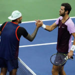 
              Karen Khachanov, of Russia, right, shakes hands with Nick Kyrgios, of Australia, at the end of a quarterfinal match the U.S. Open tennis championships, Wednesday, Sept. 7, 2022, in New York. Khachanov won the match. (AP Photo/Frank Franklin II)
            