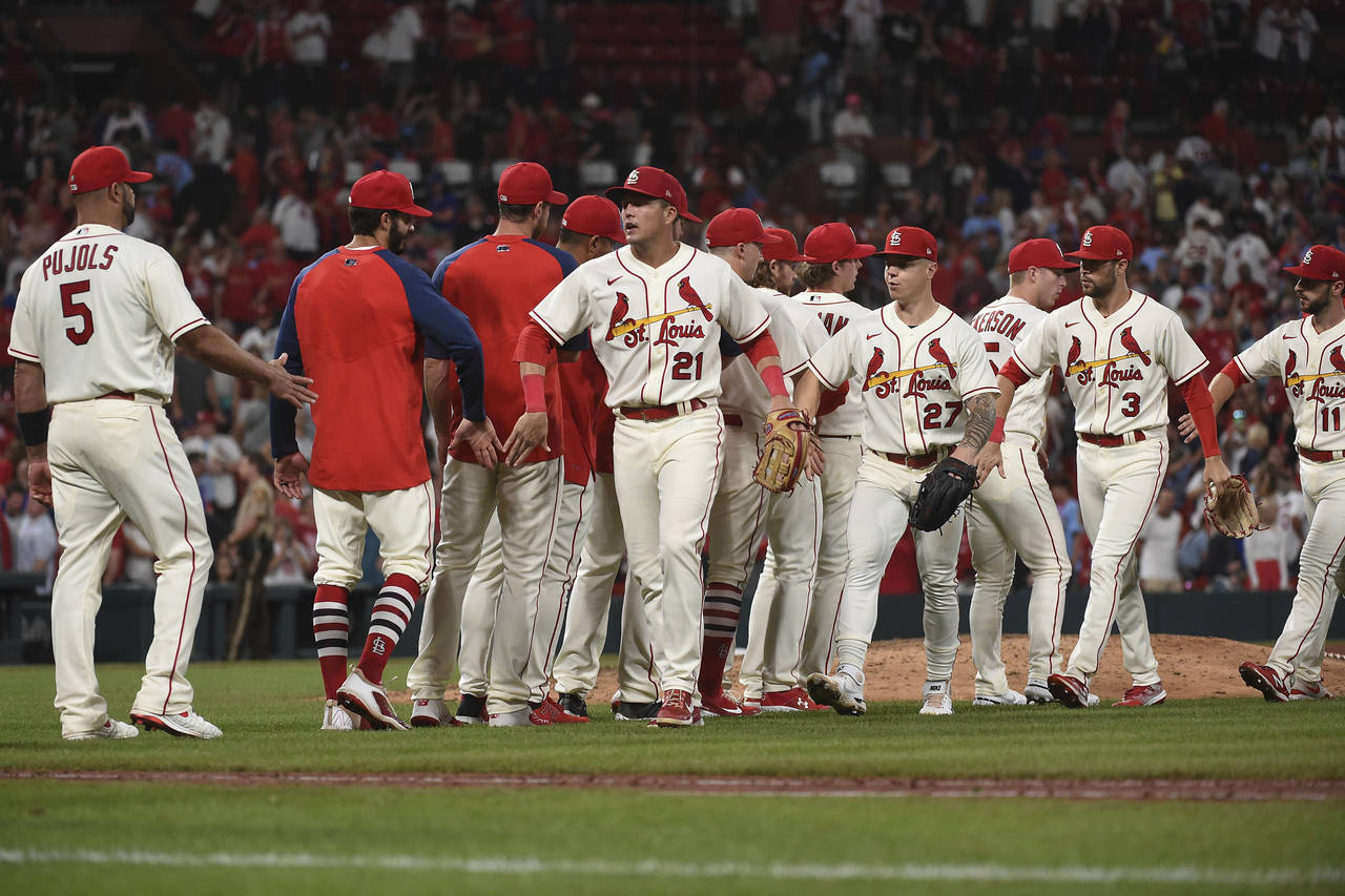 St. Louis Cardinals celebrate their team's 8-4 victory in a baseball game against the Chicago Cubs ...