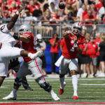 
              Ohio State quarterback C.J. Stroud, right, throws a apss against Arkansas State during the first half of an NCAA college football game Saturday, Sept. 10, 2022, in Columbus, Ohio. (AP Photo/Jay LaPrete)
            
