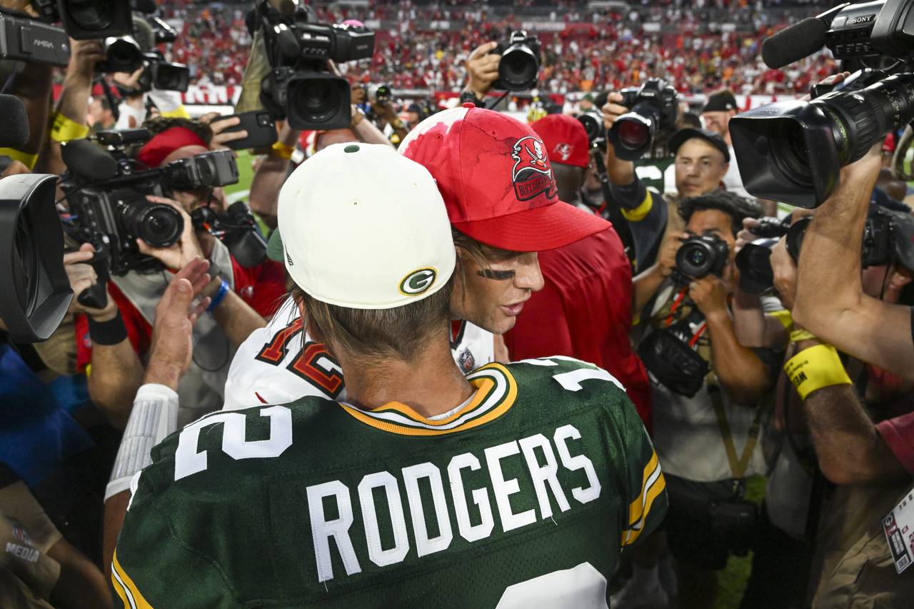 Green Bay Packers' Aaron Rodgers hugs Tampa Bay Buccaneers' Tom Brady after an NFL football game Su...