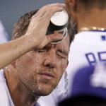 
              Los Angeles Dodgers starting pitcher Tyler Anderson pours water on his face prior to a baseball game against the San Francisco Giants Tuesday, Sept. 6, 2022, in Los Angeles. (AP Photo/Mark J. Terrill)
            