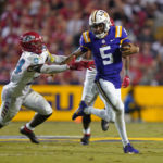 
              LSU quarterback Jayden Daniels (5) carries against New Mexico safety AJ Haulcy (24) in the second half of an NCAA college football game in Baton Rouge, La., Saturday, Sept. 24, 2022. LSU won 38-0. (AP Photo/Gerald Herbert)
            