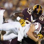 
              New Mexico State quarterback Diego Pavia, bottom, is tackled by Minnesota defensive lineman Jalen Logan-Redding (97) during the first half of an NCAA college football game Thursday, Sept. 1, 2022, in Minneapolis. (AP Photo/Abbie Parr)
            