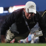 
              Purdue President Mitch Daniels does pushups after Purdue scored against Florida Atlantic during an NCAA college football game Saturday, Sept. 24, 2022, in West Lafayette, Ind. (Alex Martin/Journal & Courier via AP)
            