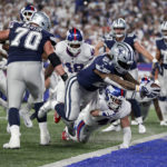 
              Dallas Cowboys running back Ezekiel Elliott (21) leaps across the goal line for a touchdown against the New York Giants during the third quarter of an NFL football game, Monday, Sept. 26, 2022, in East Rutherford, N.J. (AP Photo/Adam Hunger)
            
