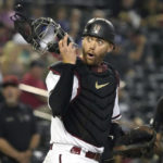 
              Arizona Diamondbacks catcher Carson Kelly reacts to the fans in the first inning during a baseball game against the Los Angeles Dodgers, Monday, Sept. 12, 2022, in Phoenix. (AP Photo/Rick Scuteri)
            